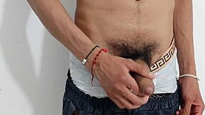 A kinky bisexual twink masturbates his uncut cock