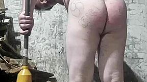 A fat Russian man endured a brutal spanking. His huge ass took a beating from a dirty broom.