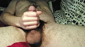Stroking my cock alone in bed until I reach orgasm