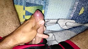 young man strokes his big cock slowly
