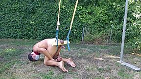 Dirty gay pig serves naked tied up outdoors doing gymnastics