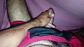 Masturbating Under The Sheets In Shorts Showing Off A Beautiful Large Cock